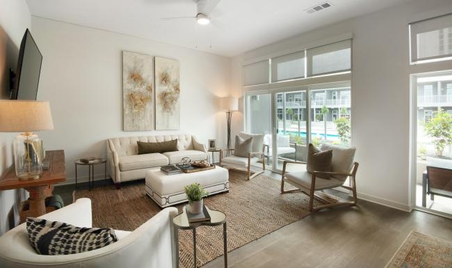 a living room with a tv, couch and chairs