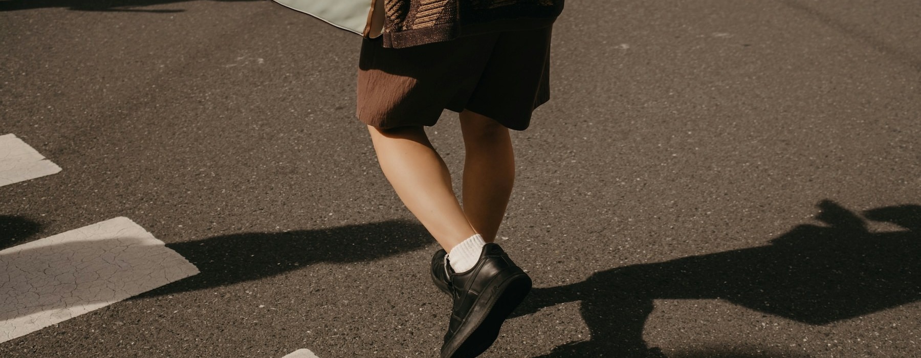 a person walking across a crosswalk