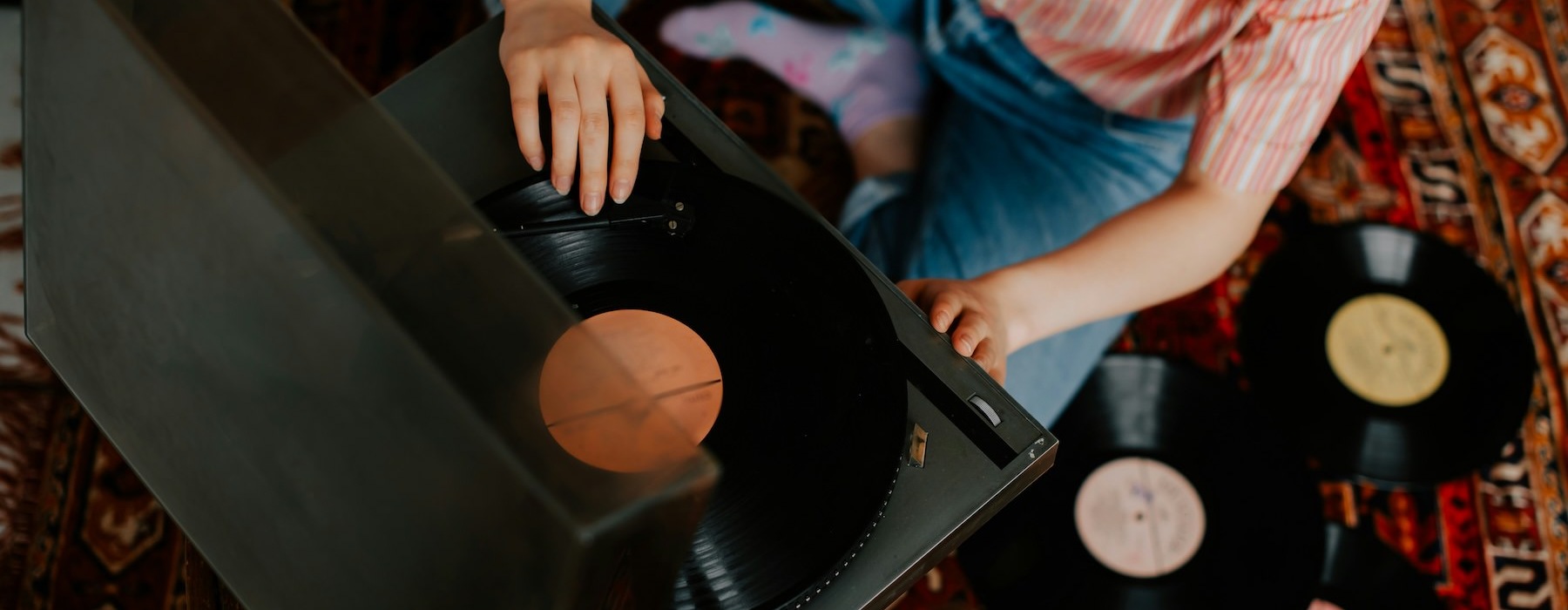 a person setting up a record player