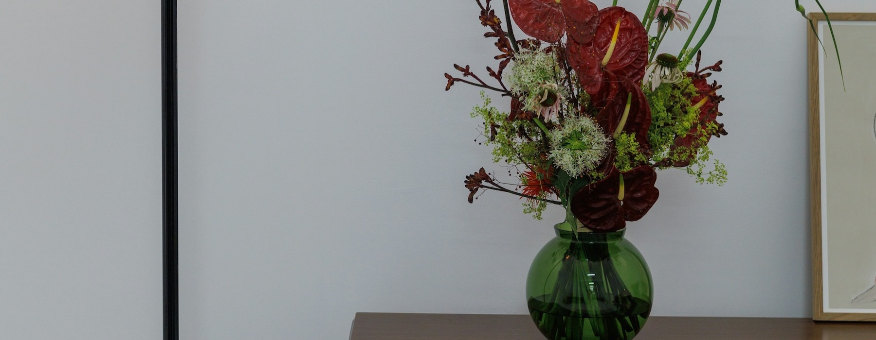 a lamp next to a vase with flowers