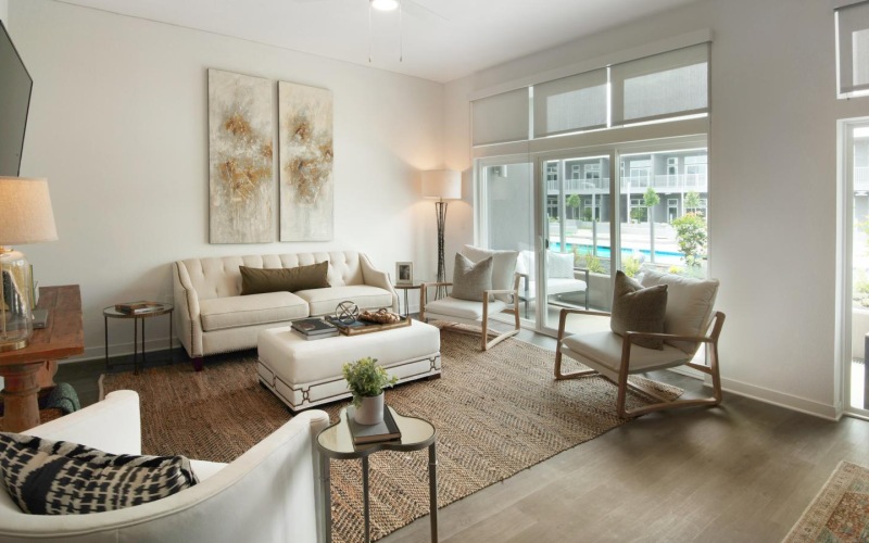 a living room with a tv, couch and chairs